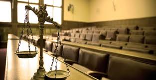 Imagen de sal&oacute;n de juicio, con una balanza en el estrado