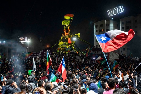 Personas celebrando en la calle con banderas