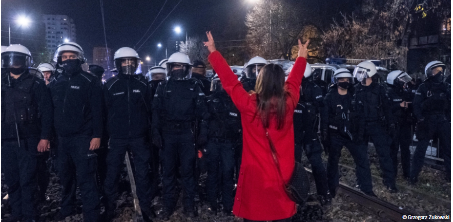 Mujer frente a hombres armados